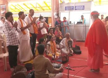 Pujya Appaji stands still for a few minutes infront of Sarvepalli Sisters during their Sangeetha Seva
