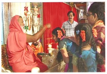 Pujya Appaji blesses with a Gold Chain after the debut concert held at Mysore Datta Peetham
