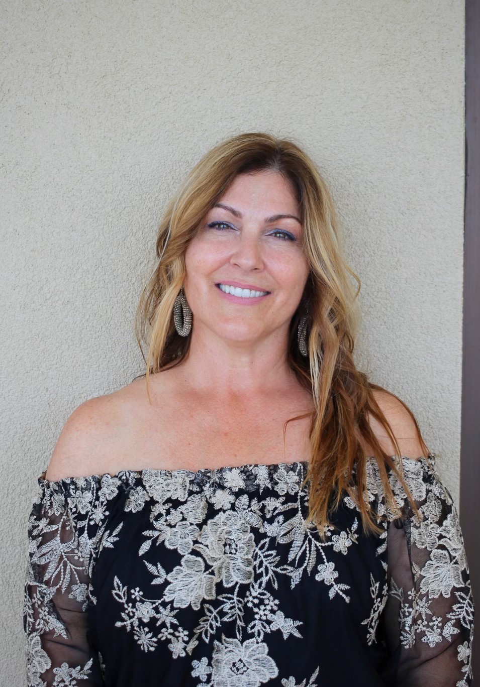 Pamela Dio smiling in a backstage theatre setting