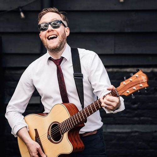Nigel Thomas performing as wedding musician with acoustic guitar