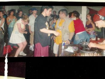 DJ Kiva spinning at a steamy warehouse rave early 2000s Brooklyn
