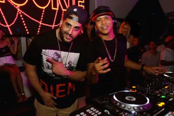 DJ Affect and DJ Chuckie at the decks during a Miami nightclub set
