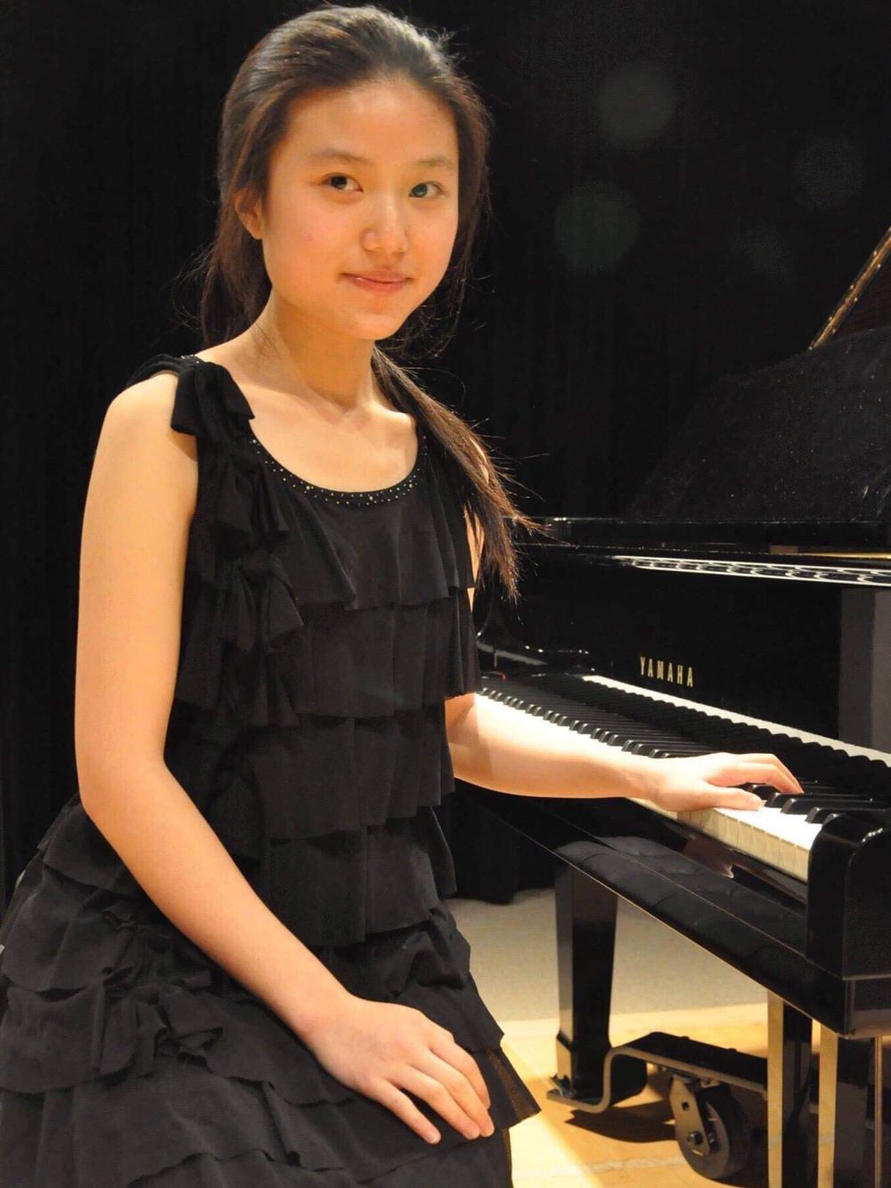 Piano teacher sitting at the piano