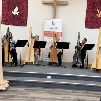 the Prince George Conservatory of Music harp ensemble performs in a recital