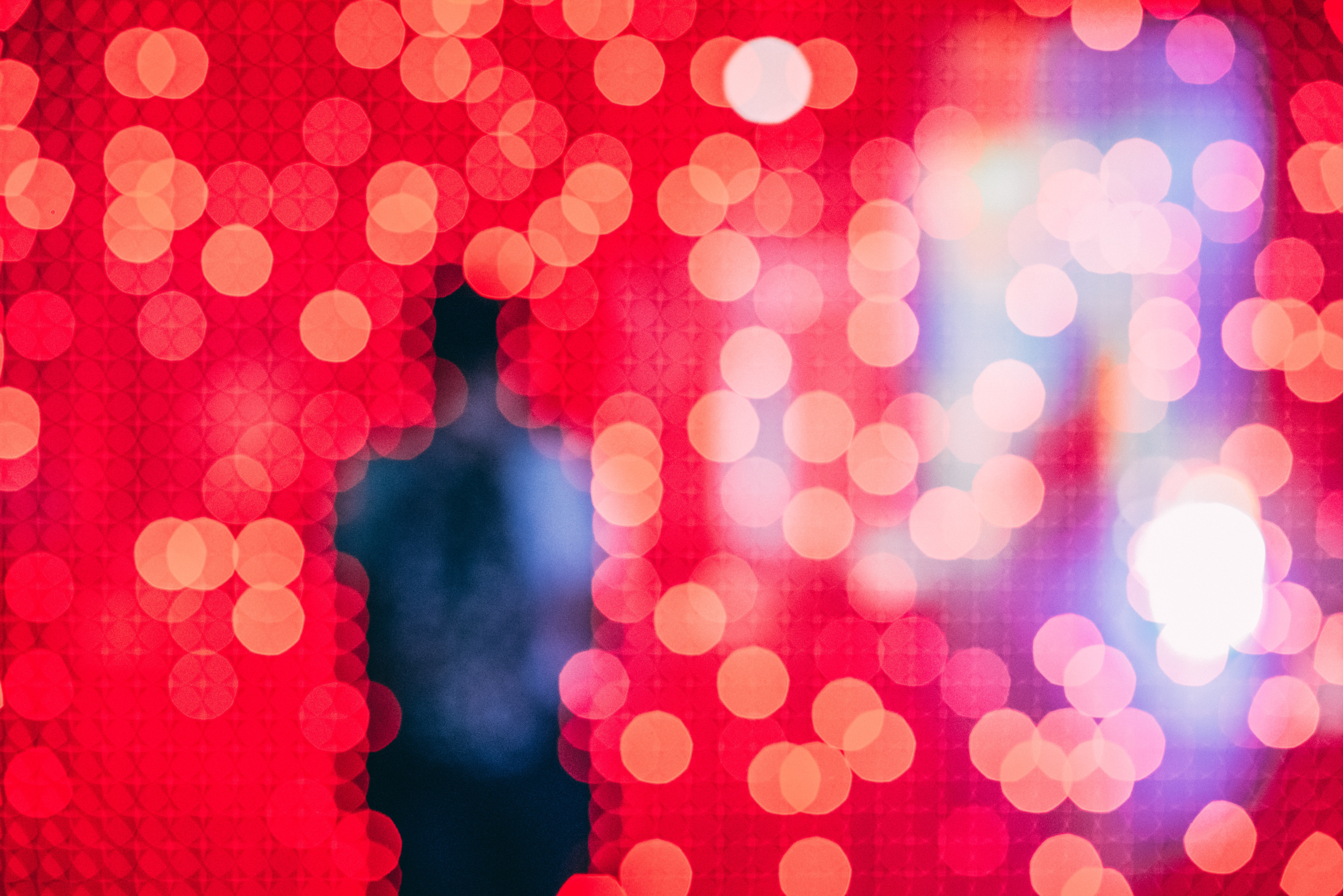 Silhouette in red light with dreamy bokeh – symbolic of reflection and inner bias.