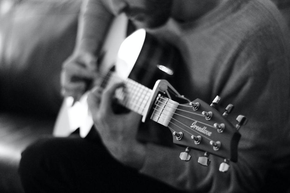 Student learning acoustic guitar during a private guitar lesson