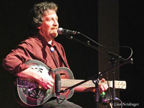 Andrew onstage with dobro at Labyrinth Walk Coffeehouse in Dallas, TX; photo by Lisa Neidinger