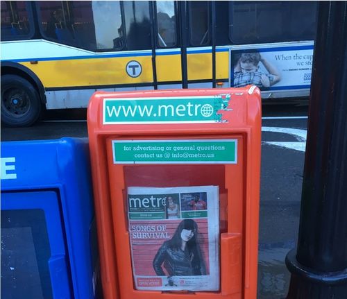 Lauren on newspaper cover with bus in background